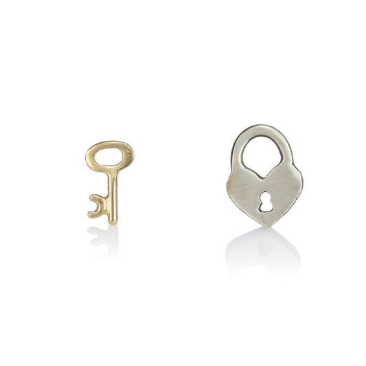 Charmed Love Stud Earrings by Luana Coonen, featuring a sterling silver heart-shaped lock and a tiny solid 14k yellow gold key.