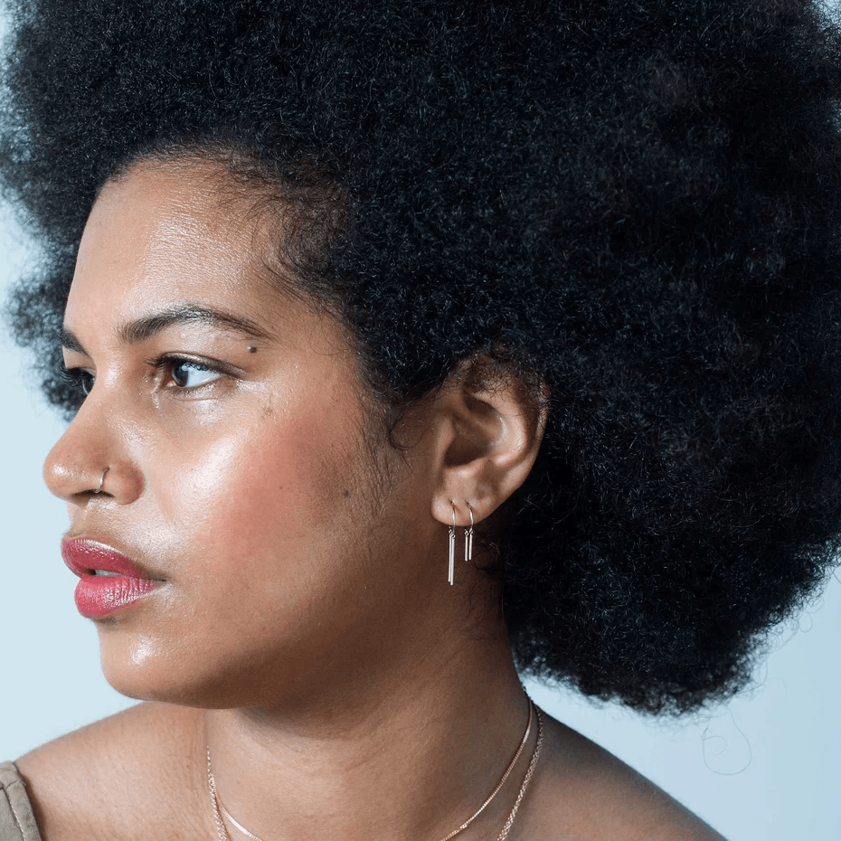 Model wearing sterling silver chime earring in a profile view showing how it hangs from the ear.
