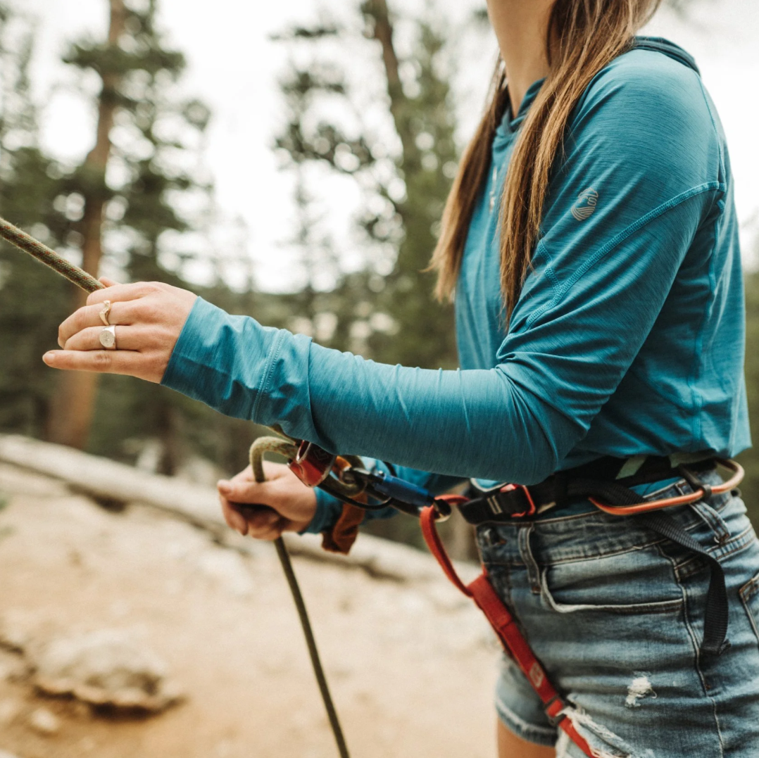 Sterling silver compass ring worn during outdoor adventure activity.