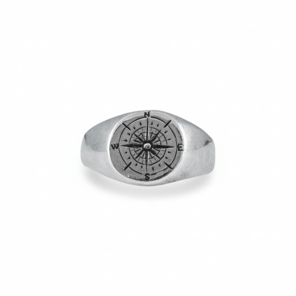 Sterling silver compass signet ring with hand-engraved compass design on the face.
