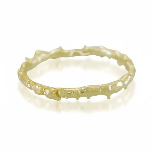 Hand-carved 14k yellow gold Coral Stacker Ring by Alexis Pavlantos, featuring an organic coral-inspired texture and delicate sculptural band on a white background.