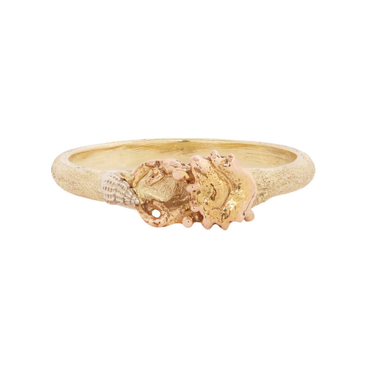 Hand-carved Crab Stacking Ring by Alexis Pavlantos in 14k yellow, rose and white gold, featuring a miniature sculptural crab holding a seashell on a textured gold band.