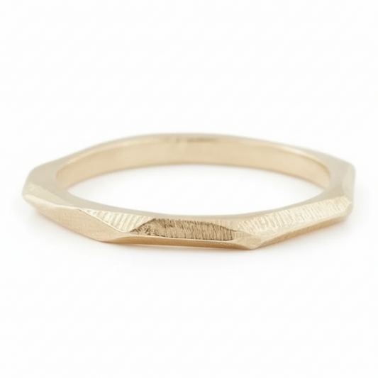 Crag Ring in 14k yellow gold, showcasing its faceted raw-surface design.