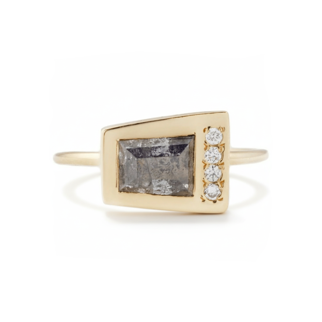 Product image of the Crescendo Ring featuring a tapered baguette salt and pepper diamond with four white diamonds set in solid 18k yellow gold.