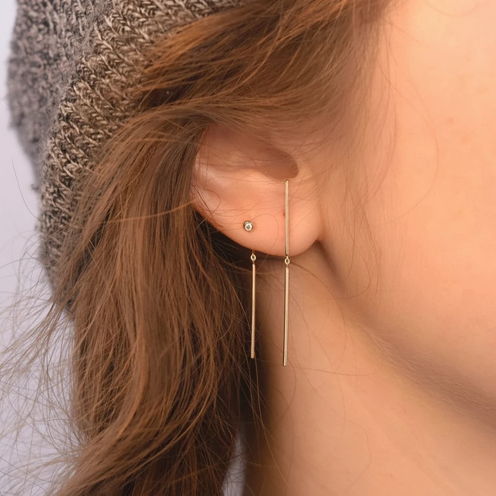 Diamond Chime Stud earring in 14k gold worn on ear, stick style