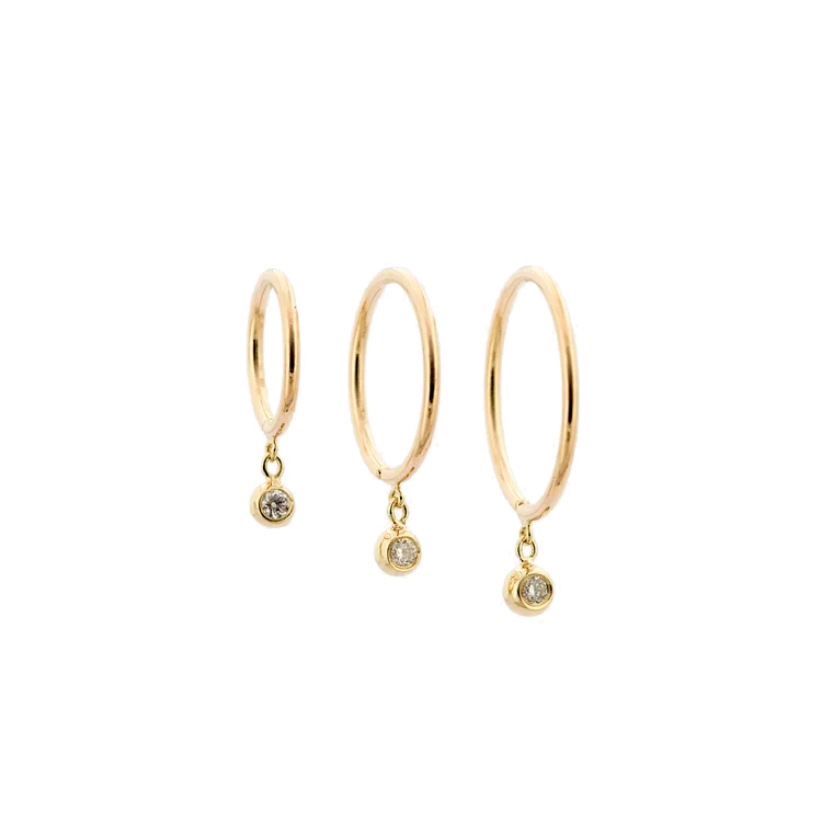 Single 14k gold diamond droplet huggie earring shown on a white background.
