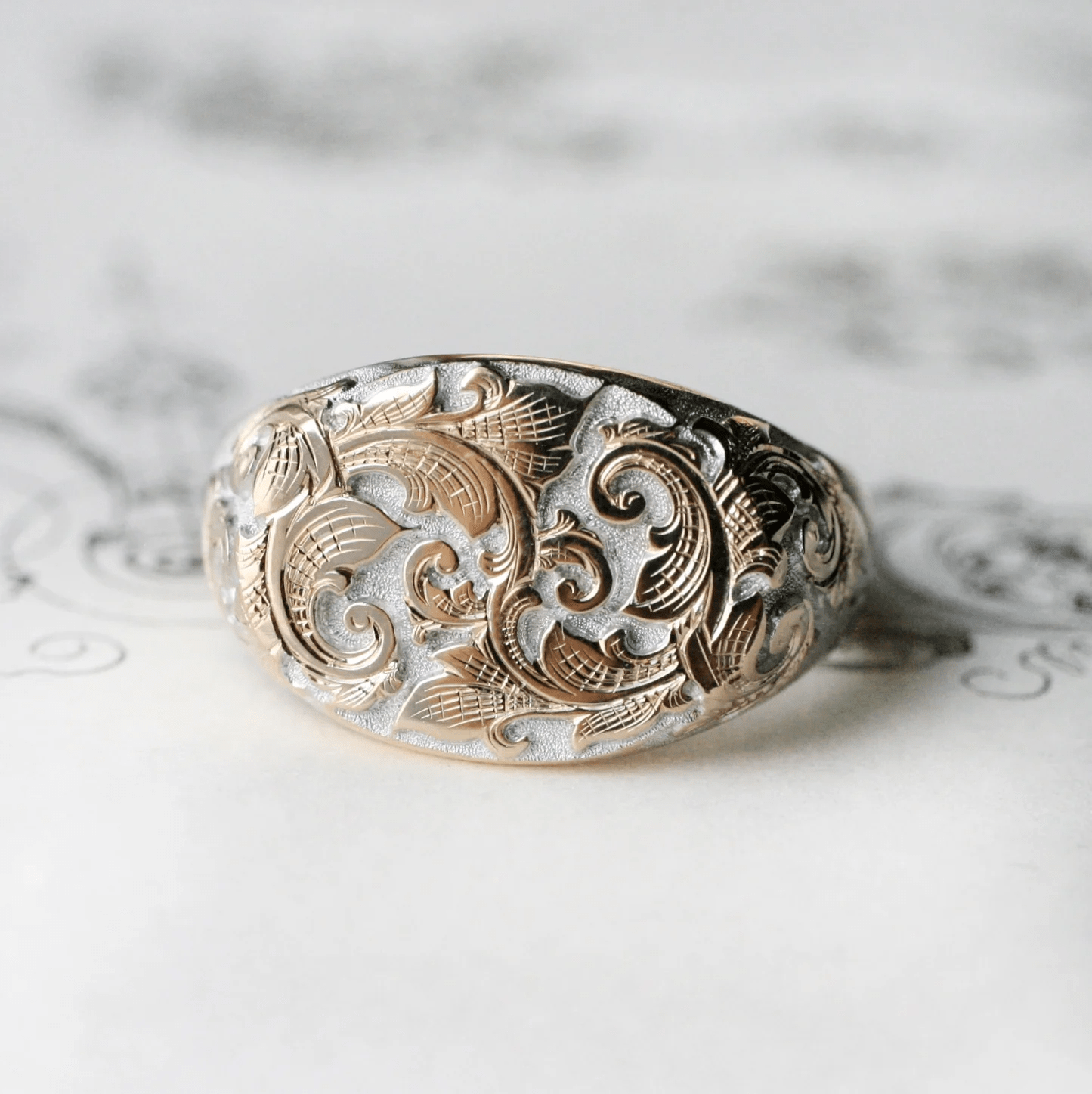 Front display of the East-West Acanthus Signet Ring in sterling silver with 14k gold details.