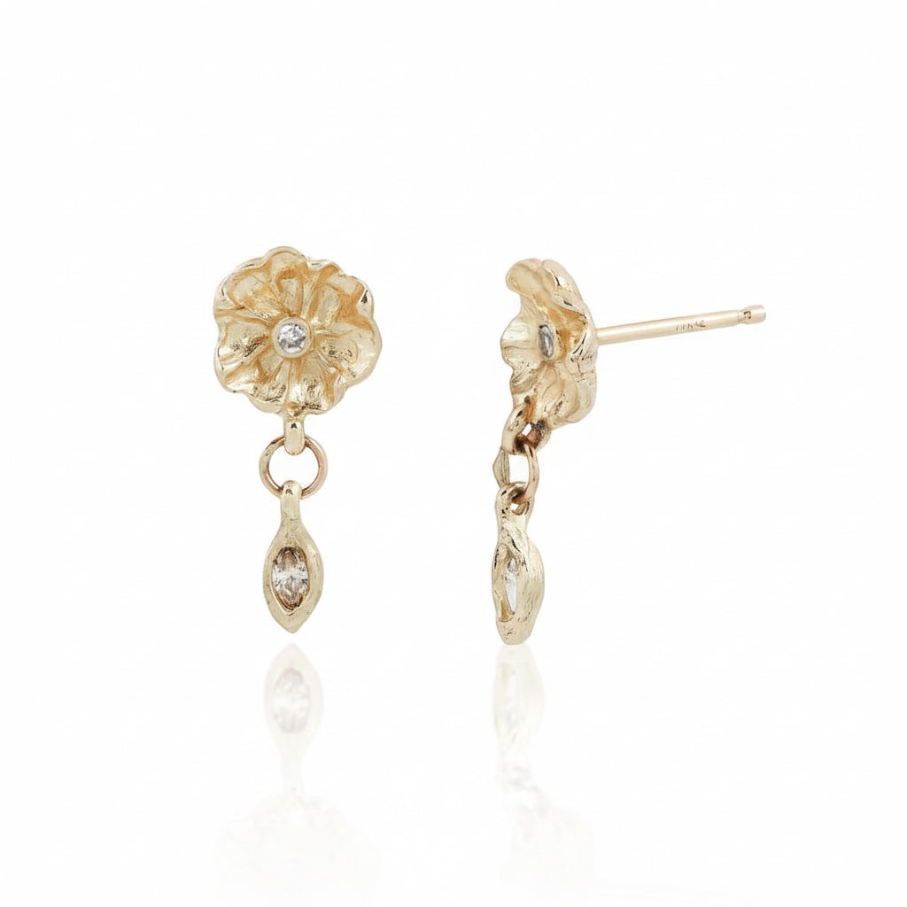 Side and front views of Efflorescent Diamond Dangle Earrings by Alexis Pavlantos, handcrafted in recycled 14k yellow gold with sculptural flower studs and dangling marquise diamonds.