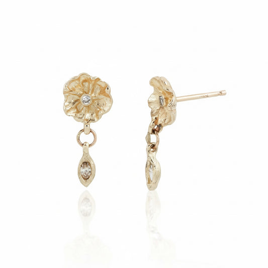 Side and front views of Efflorescent Diamond Dangle Earrings by Alexis Pavlantos, handcrafted in recycled 14k yellow gold with sculptural flower studs and dangling marquise diamonds.