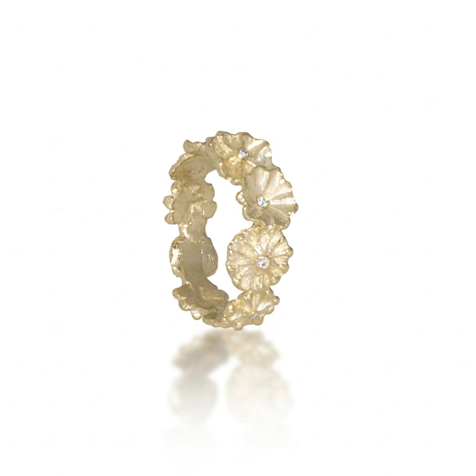 Side view of the Efflorescent Sparkle Ring by Alexis Pavlantos, handcrafted in 14k yellow gold with sculpted floral petals and five 1.5mm natural melee diamonds.