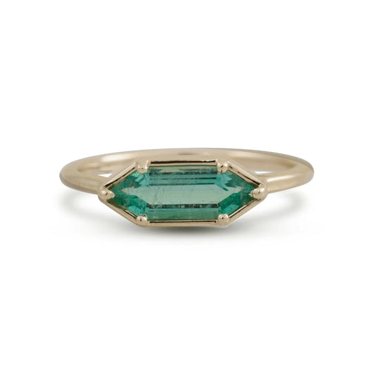 Michaela Farkasovska 14k yellow gold ring featuring a natural hexagon-cut Zambian emerald in a minimalist geometric setting.
