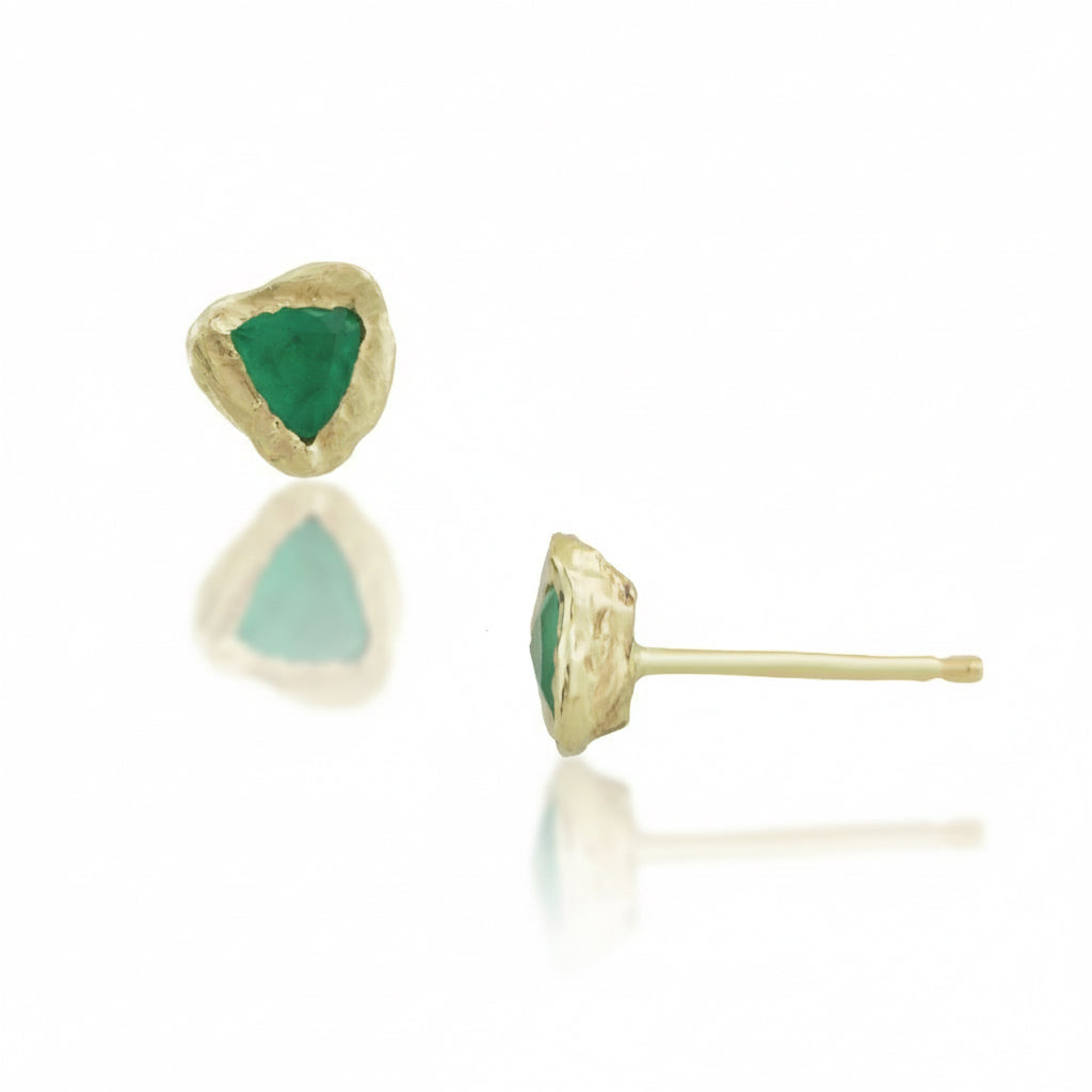 Handcrafted 14k yellow gold stud earrings by Alexis Pavlantos featuring 4mm trillion-cut green emeralds in organic, rock-textured settings, shown from front and side.