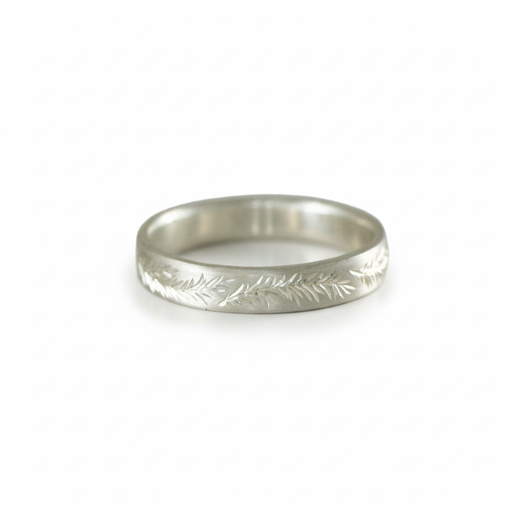 Sterling silver rosemary engraved band on white background – delicate leaf pattern.