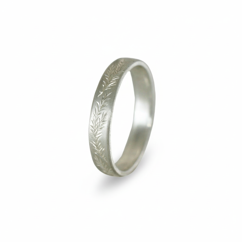 Sterling silver rosemary engraved band on white background – fine leaf pattern.