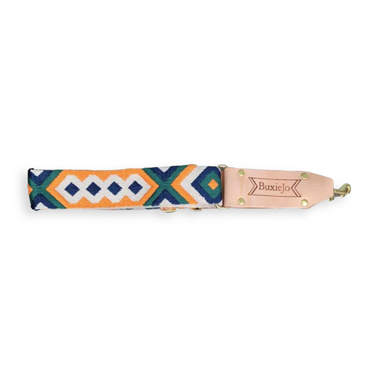 Fancy Cross-Body Strap by Kerrin Pogozelski of BuxieJo Bags, featuring a colorful blue, orange, black, and white geometric woven pattern with adjustable hardware.