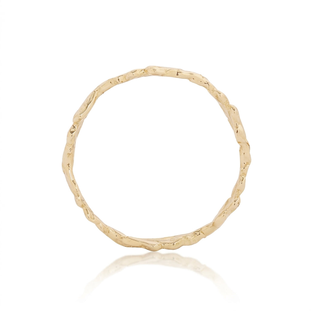 Side view of the handmade 14k yellow gold Fern Ring showing its continuous wreath-like arrangement of intricately carved fern leaves and organic texture.
