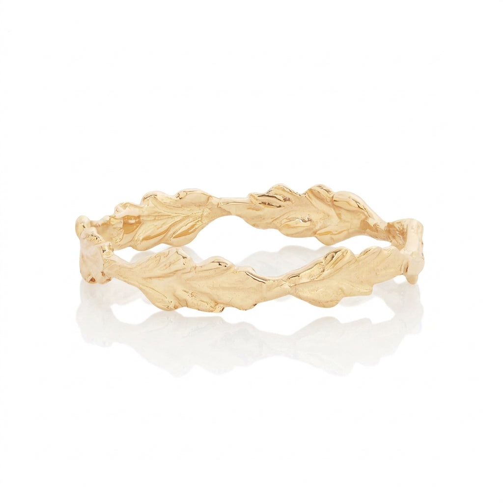 Hand-carved 14k yellow gold Fern Ring by Alexis Pavlantos, featuring overlapping sculptural fern leaves forming a delicate, nature-inspired stacking band.