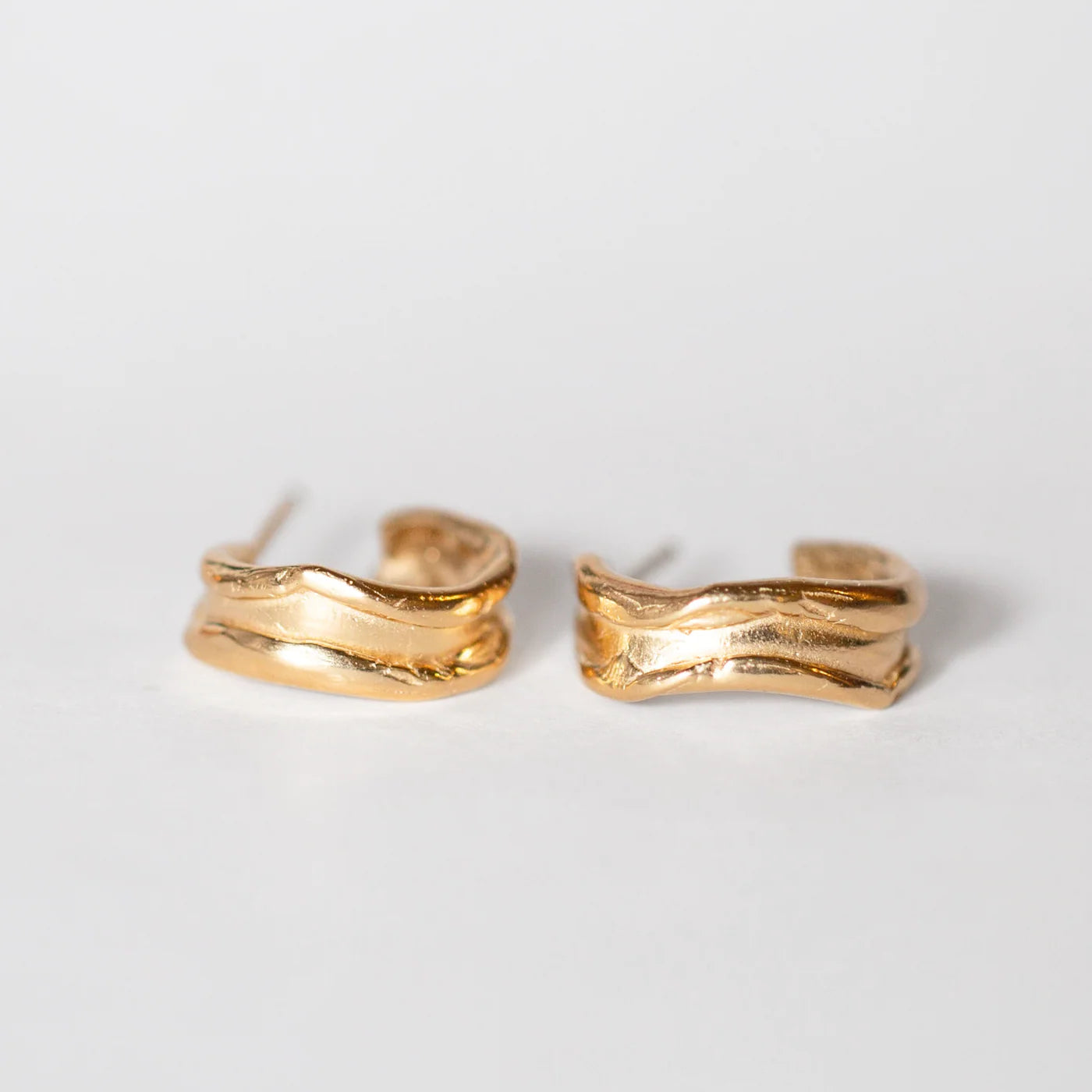 14k gold vermeil Fluvial Hoops shown in sculptural nested stack