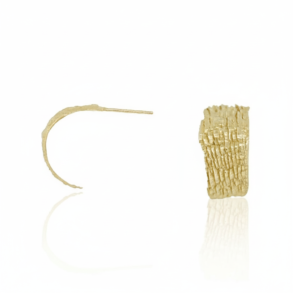 Hand-carved 14k yellow gold Fractured Sedimentary Hoop Earrings by Alexis Pavlantos, showing side and front views of the lightweight hoops with geological layered texture.