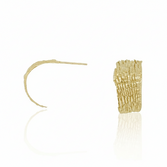 Hand-carved 14k yellow gold Fractured Sedimentary Hoop Earrings by Alexis Pavlantos, showing side and front views of the lightweight hoops with geological layered texture.