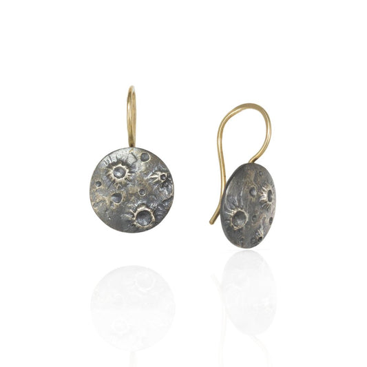 Full Moon Dangle Earrings by Luana Coonen, featuring textured oxidized sterling silver moons suspended from 14k yellow gold ear wires.
