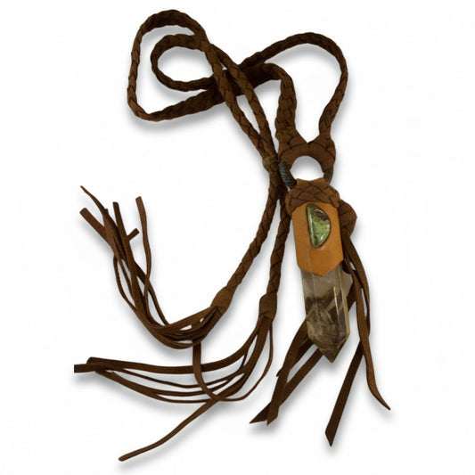 One-of-a-kind gaspeite and quartz crystal necklace by Kelly Horrigan Handmade, featuring repurposed brown deerskin leather, an antique brass ring, and long leather tassels.