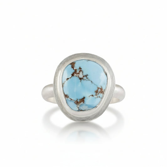 Gold Hill Turquoise Ring by Ana Eugenia, featuring a natural oval sky-blue turquoise cabochon with golden-brown matrix in a brushed sterling silver bezel setting.
