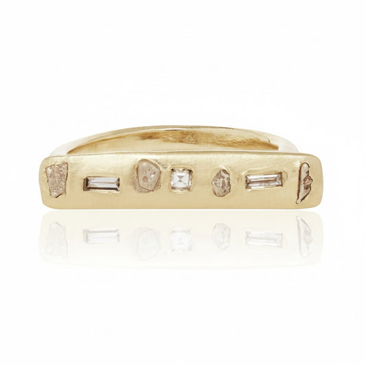 Handcrafted Gonia Ring by Alexis Pavlantos, featuring a slim 14k yellow gold bar set with 0.20 carats of repurposed diamonds in assorted cuts and sizes.