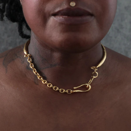 Hand Etched Chain Choker Necklace by Lingua Nigra worn around the neck, featuring a sculptural 22k gold-plated brass design with a textured front.