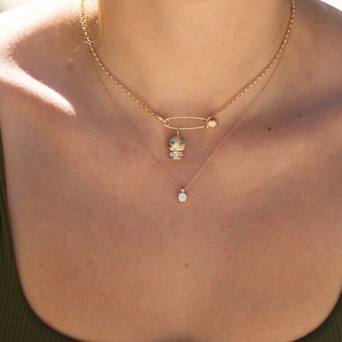 Detailed view of the 14k gold hand safety pin charm showing sculpted hand and pin head.