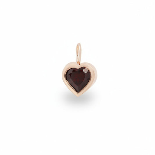 Petite heart-shaped red garnet charm set in polished 14k rose gold with a gold bail, handcrafted by Amanda George.