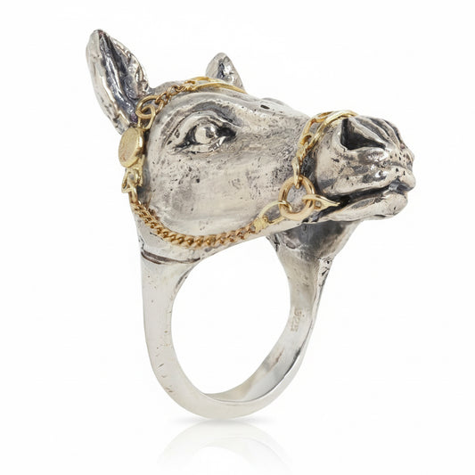 Handcrafted sculptural horse ring by Alexis Pavlantos in sterling silver, featuring a detailed horse head with an articulated 14k yellow gold bridle and expressive hand-carved features.