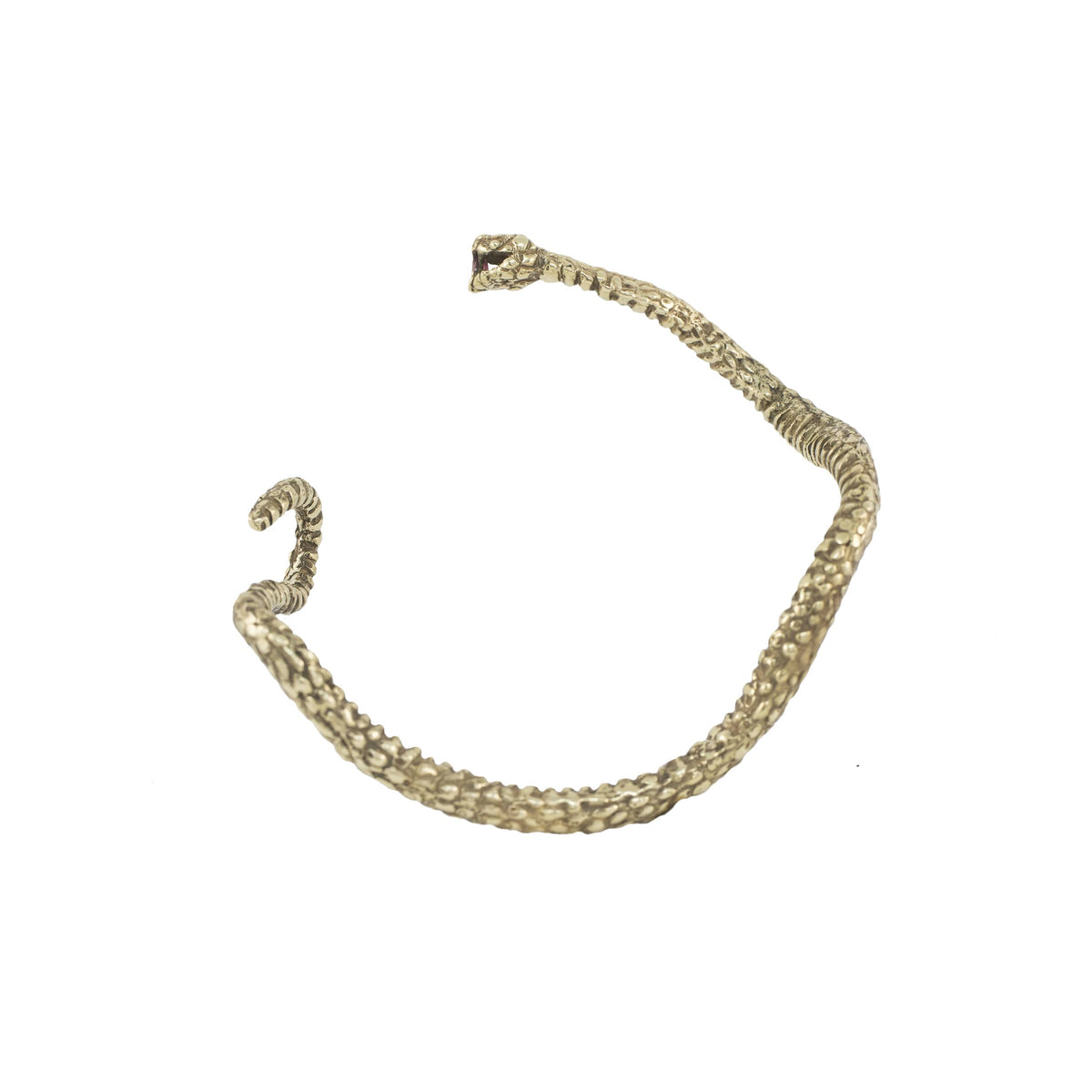 Sculptural brass Ichos Snake Cuff by Alexis Pavlantos, featuring a textured serpent design with a ruby gemstone set in its mouth.