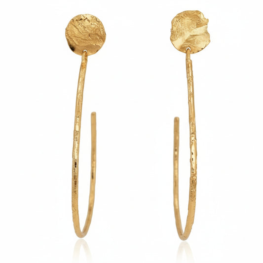 Jumping Through Extra Large Hoop Earrings by Lingua Nigra, handcrafted in 22k gold-plated brass with elongated sculptural hoops and textured circular tops.