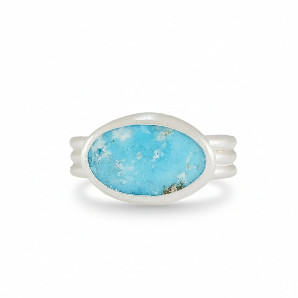 Silver ring with a turquoise stone on a white background