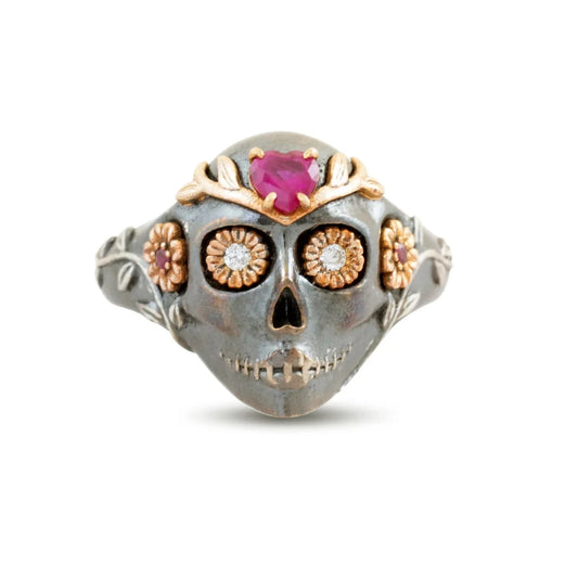 La Flora Skull Ring by Michaela Farkasovska featuring oxidized sterling silver, ruby eyes, and 14k gold floral accents.
