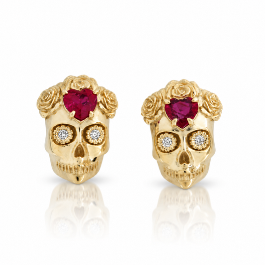 La Flora Skull Stud Earrings by Michaela Farkasovska in 14k yellow gold, featuring heart-shaped rubies, diamond eyes, and sculpted rose details.