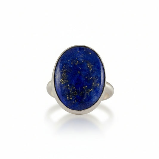 Lapis Lazuli Ring by Ana Eugenia, featuring a deep ultramarine blue oval lapis lazuli cabochon with natural golden pyrite flecks set in brushed sterling silver.