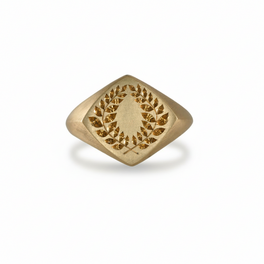 Laurel Signet Ring by June Cream of Blue Blue Driver, featuring a hand-engraved laurel wreath motif on a diamond-shaped solid 14k yellow gold signet ring.