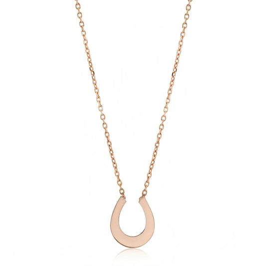 Minimalist horseshoe pendant necklace in 14k yellow gold by Amanda George, suspended from a delicate 18-inch gold cable chain.