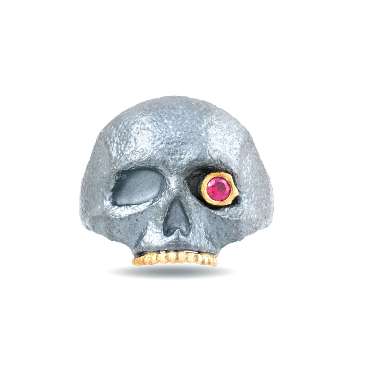The Masque of the Red Death Skull Ring by Michaela Farkasovska, featuring an oxidized sterling silver skull with a ruby eye and 14k yellow gold accents.