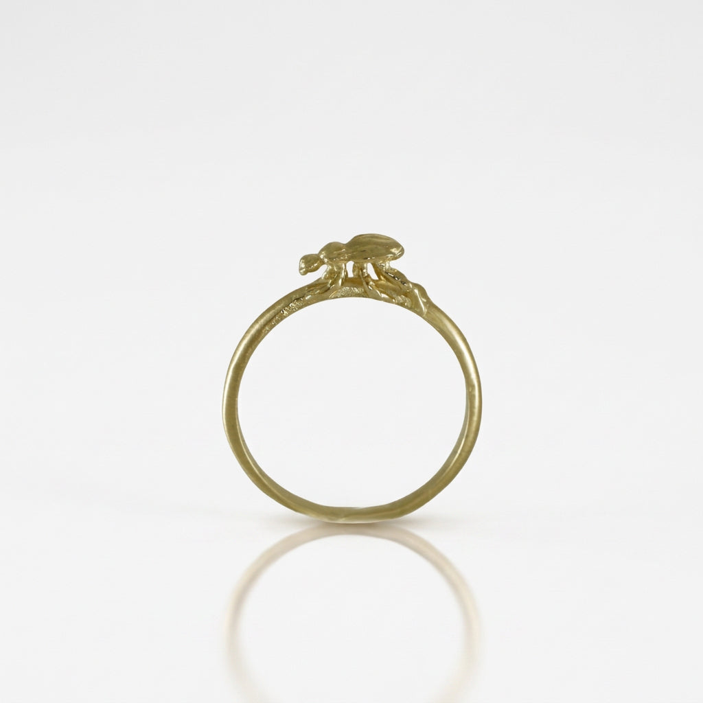 Side profile of the 14k yellow gold Medium Beetle Stacking Ring showing the raised beetle sculpture and slim, polished gold band.