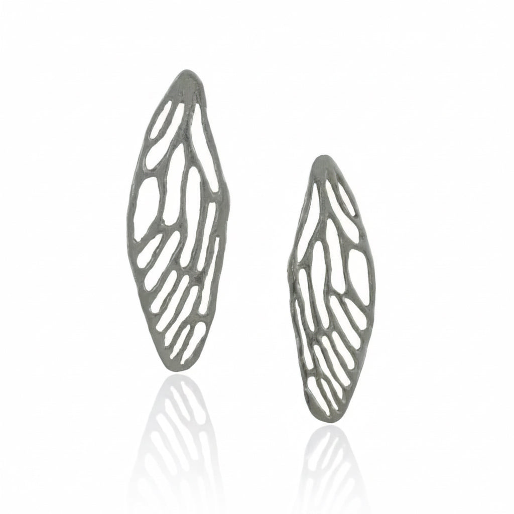Angled view of sterling silver cicada wing earrings showing their delicate cutout patterns and dimensional handcrafted design.