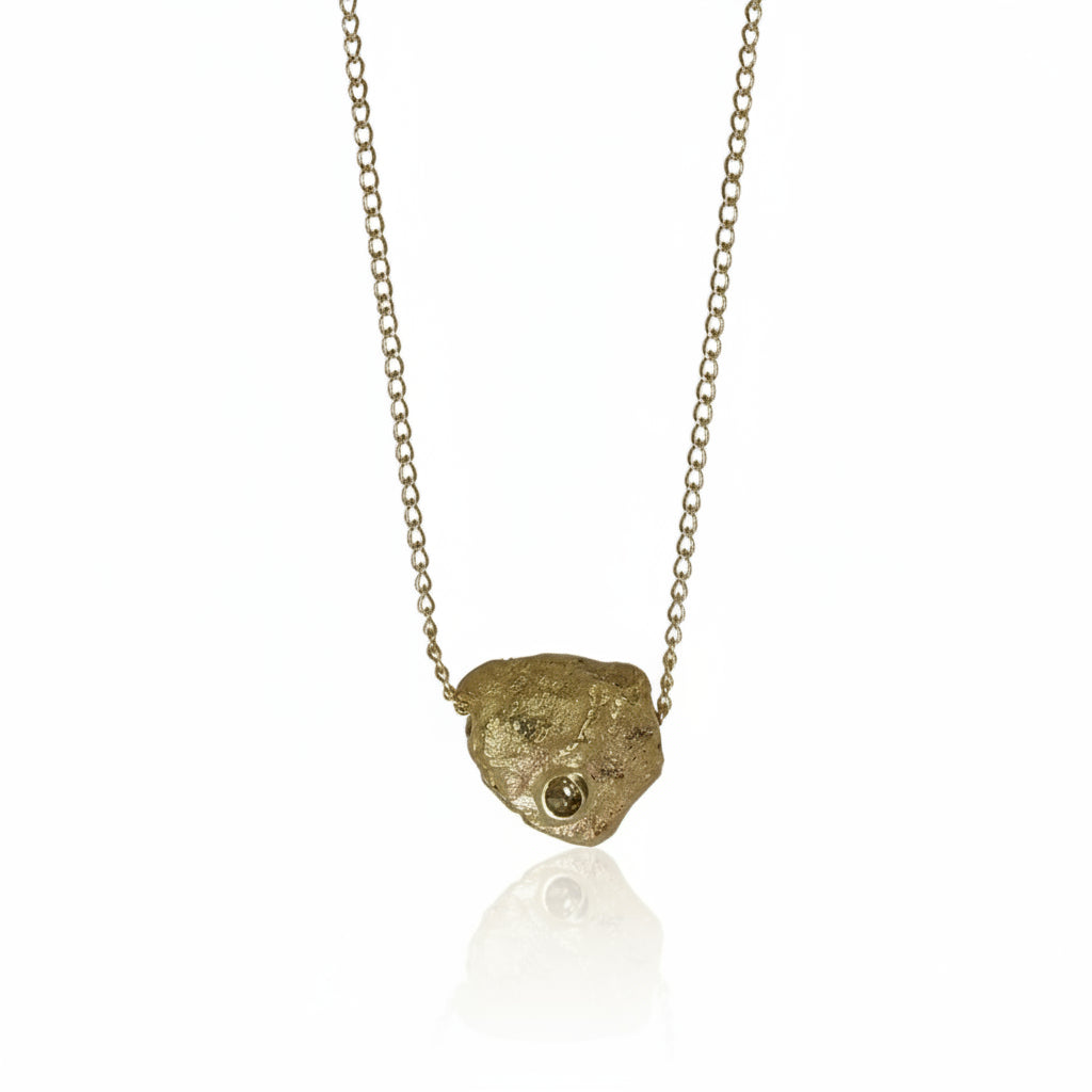 Hand-carved Medium Gold Rock Pendant in recycled 14k yellow gold by Alexis Pavlantos, featuring an organic rock texture and a natural rose-cut diamond on a delicate 16-inch gold chain.