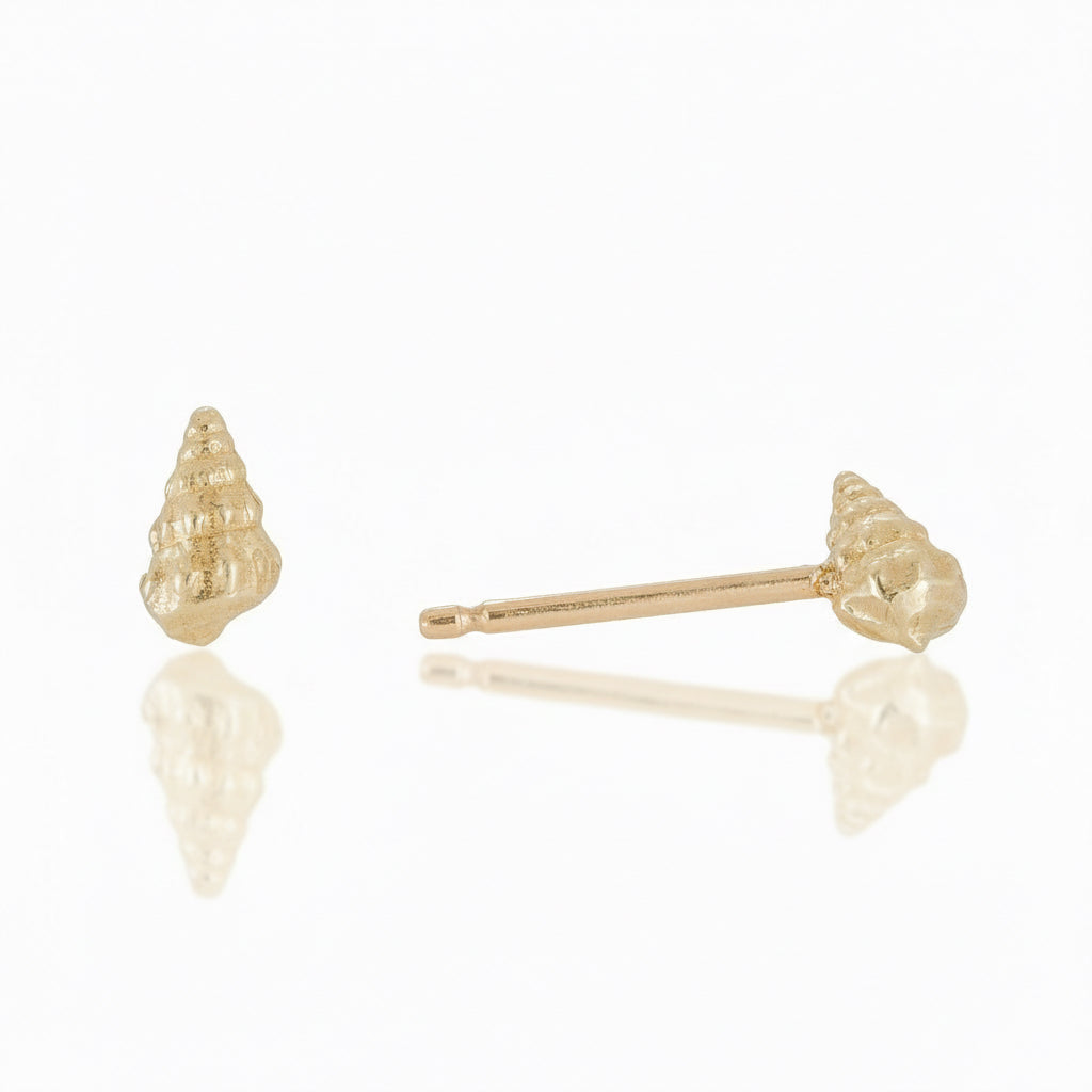 Front and side views of handcrafted Medium Wentletrap Seashell Stud Earrings in solid 14k yellow gold by Alexis Pavlantos, featuring intricate spiral shell textures and delicate gold posts.