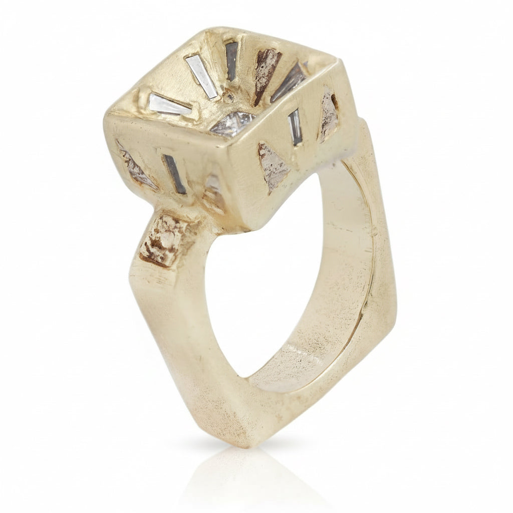 Three-quarter view of the Mesa Ring showing its architectural gold setting, radiant-cut diamond, baguette accents, and sculptural band.