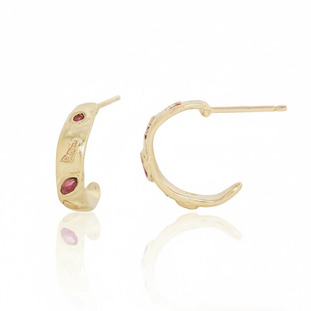 Front and side views of 14k gold Micro Meta Hoop Earrings featuring ruby accents, organic mixed-metal textures, and delicate open hoop shapes with straight posts.