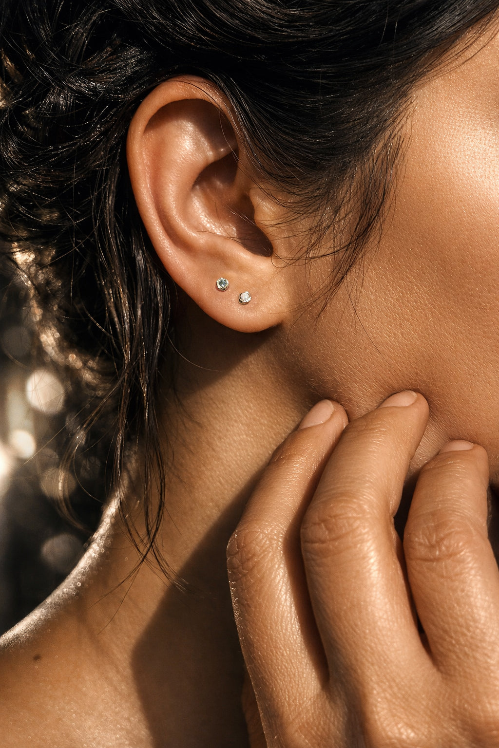 Petite 14k yellow gold Micro Petra birthstone stud worn on the ear, showing its delicate size and minimalist everyday styling.