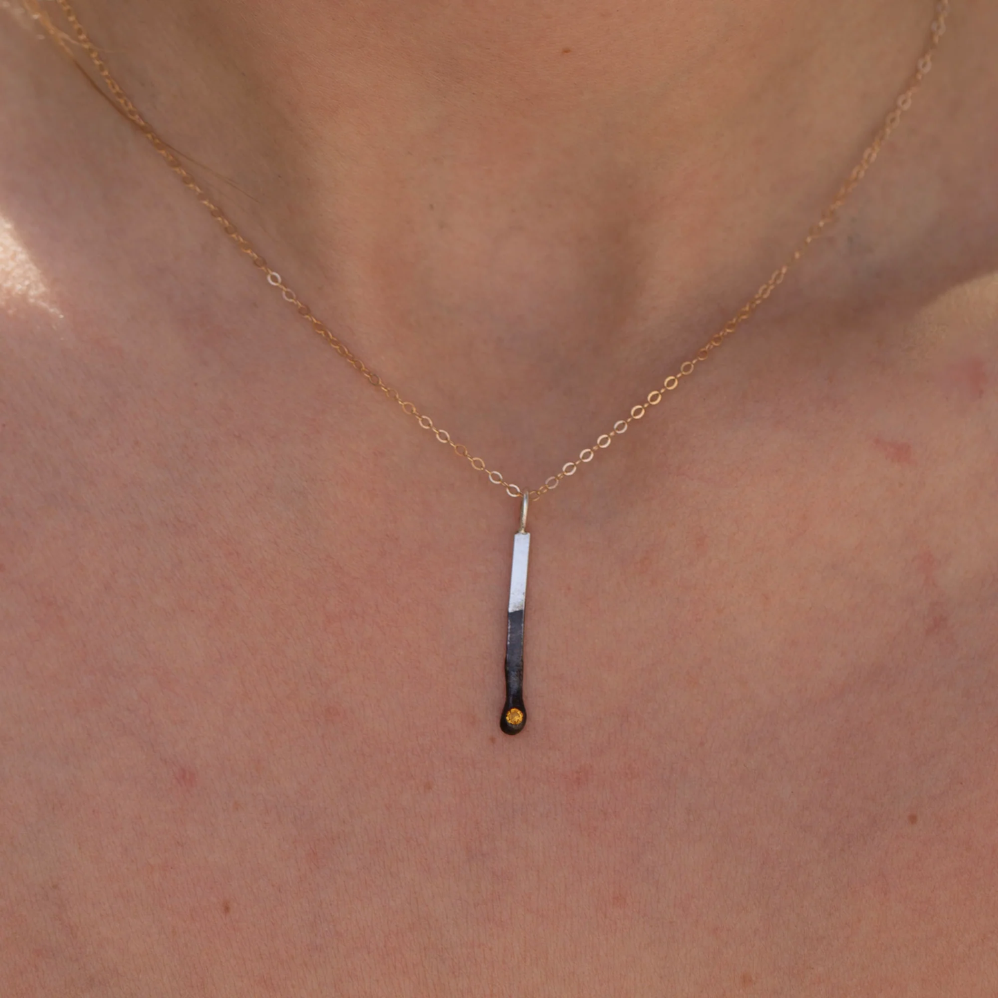 Sterling silver mini match charm with citrine shown on model neckline