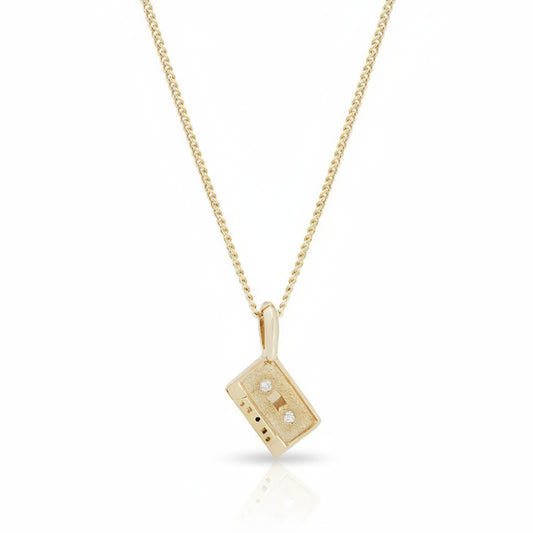 KIMA Mini Mixtape Necklace featuring a miniature 14k yellow gold cassette tape pendant with flush-set white diamonds on a gold chain.